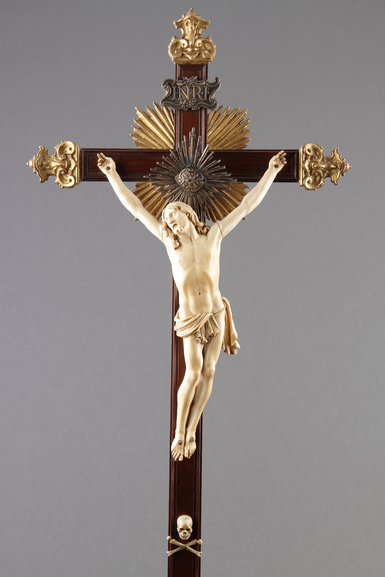 South Netherlandish / German Carved Ivory Crucifix Figure of Christ with a Silver Halo and Sacred Motto Affixed to a Rosewood Cross